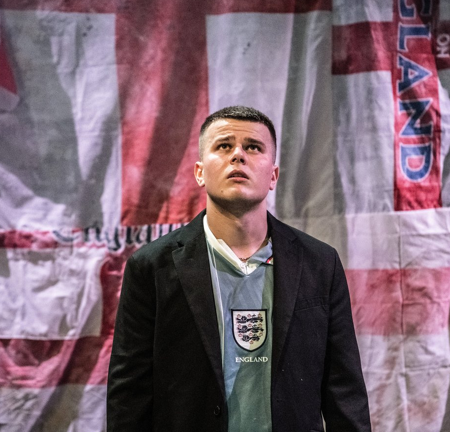 man with England flag in background